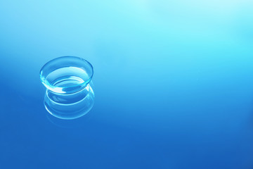 Contact lens on color glass background