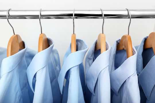 Rack with clean clothes after dry-cleaning on hangers