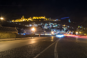 Fototapeta na wymiar night view of Tbilisi, the bright lights of Narikala fortress and the Old Town of Tbilisi