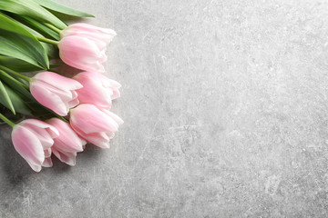 Beautiful tulips for Mother's Day on grey background, top view