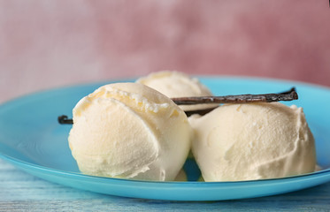 Plate with tasty vanilla ice cream on table, closeup