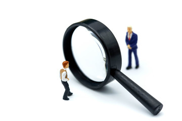 Miniature people : young businessman with magnifying glass of Successful businessman,Business Growth concept.