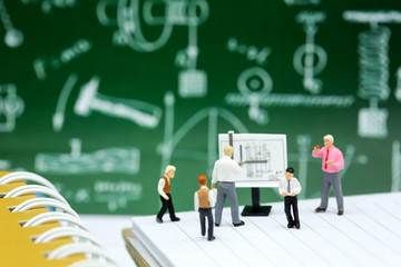 Miniature people : Teacher and children with book and school background. Back to school , Education concept.