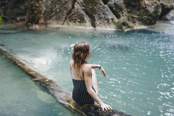 Fototapeta premium White woman enjoying the waterfall