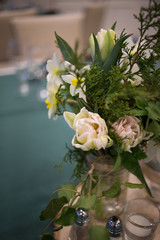 Yellow and White Spring Flower Centerpiece in a Glass Canning Jar on a Wooden Slab