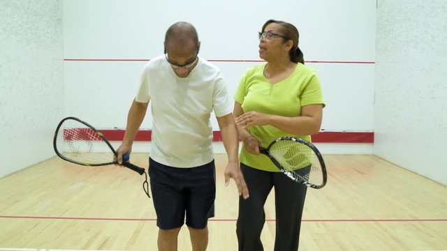 Mature couple leaving a squash court