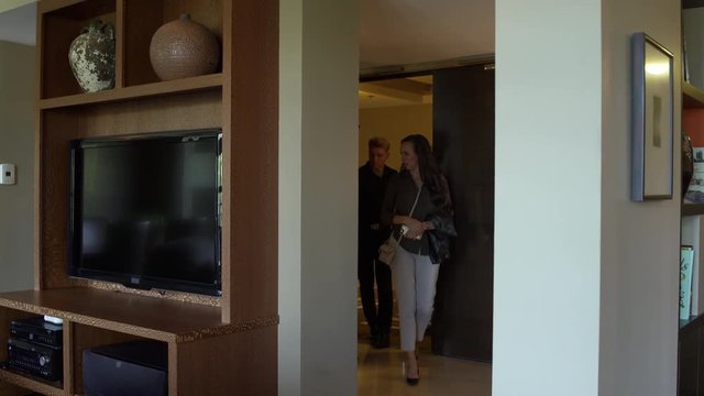Young couple entering a suite with a bellboy