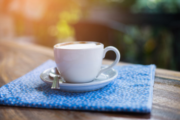 Coffee espresso on wood table nature background in garden,warm tone