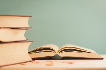 still life of old books on the desk,table with light green background.
