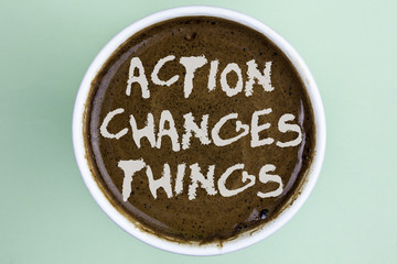 Writing note showing  Action Changes Things. Business photo showcasing doing something is like chain Improve Reflects written on Coffee in a Cup on the plain background.