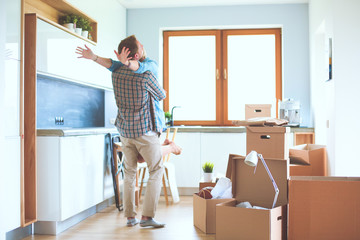 Portrait of young couple moving in new home. Young couple