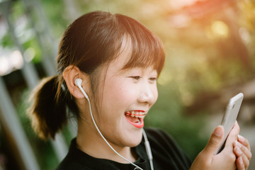 Happy woman enjoying melody from headphones