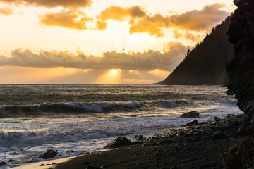 A colorful beach sunset over the black sands of the Lost Coast backpacking trail in California