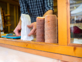 Bread sugar sweet Trdelnik - traditional national czech street desert, baking on the street of Prague.ฺฺ