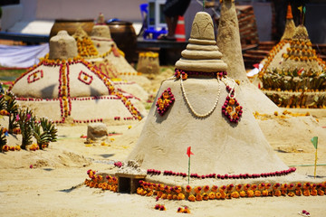 Sand Pagodas at Songkran festival or Thai New Year.Carrying sand to temple and forming sand pagodas.