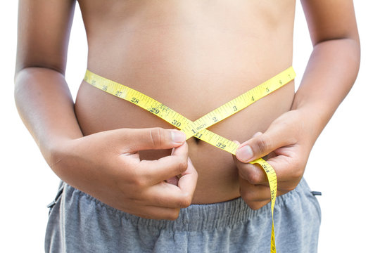 Close up hands boy measuring tape on abdominal surface , Fat and  health care concept.