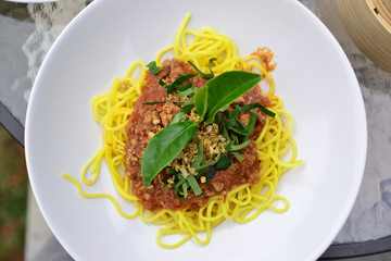Healthy plate of Italian spaghetti topped with a tasty tomato and ground beef