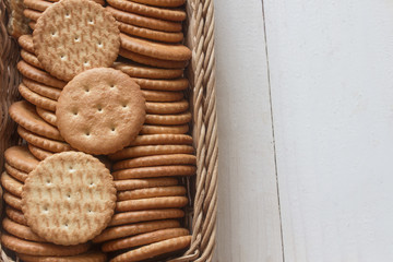 a full basket of baked crispy little crackers vertically