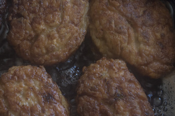 process of frying in a frying pan of domestic juicy cutlets