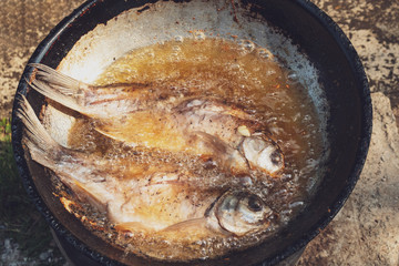 Frying pickled fish by using a charcoal stove.A native of Northeast Thailand.Rural lifestyle.