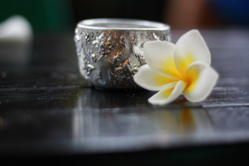 Plumeria flower and water bowl