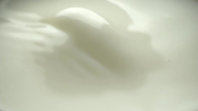 milk dropping and splashing in slow motion