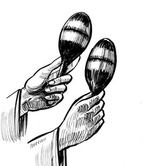 Hands holding maracas. Ink black and white drawing