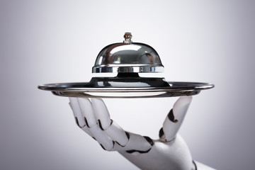 Robot Holding Service Bell In Plate