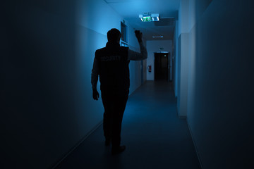 Security Guard Standing In Corridor Of The Building