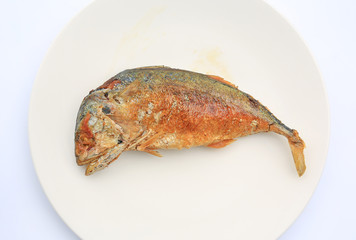 Fried mackerel on white plate.