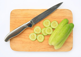 Sliced and cucumber on wooden board background.