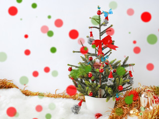 Christmas tree and decoration on white background with colorful bokeh.
