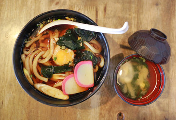 Top view of Udon serve with miso soup on the wood table. Japanese food.