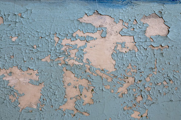old blue cracked paint on the wall