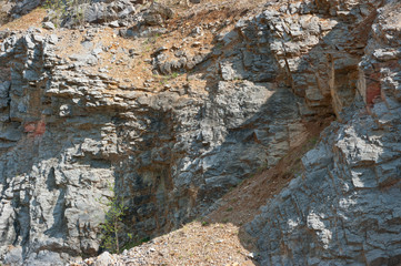 Fototapeta premium A close-up view of the walls of an old abandoned quarry. In this quarry, limestone was mined.