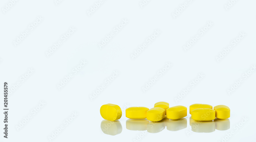 Wall mural yellow tablets pills isolated on white background with copy space for text. ibuprofen tablets pills.