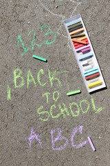 Fototapeta na wymiar Back to school sigh written with colored chalks on a pavement. Drawing Back to school on an asphalt. and vacation concept. Education concept. School and fun time. No sharpen. 