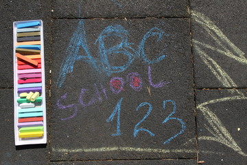 Obraz premium School, ABC and 123 sigh written with colored chalks on a pavement. Drawing Back to school on an asphalt. and vacation concept. Education concept. School and fun time. No sharpen. 