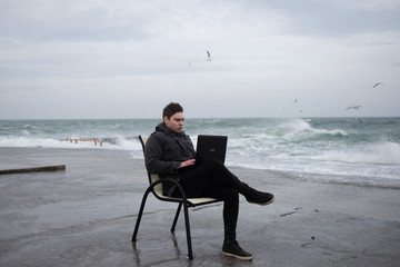 the guy enthusiastically works on the beach near the sea