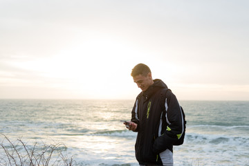Fototapeta premium the guy saw something in the phone and smiled sweetly