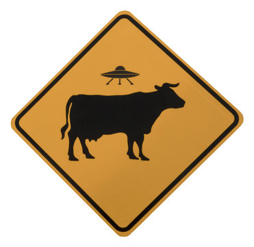 Cow Alien Abduction Road Sign, isolated, seen on the historic Turquoise Trail between Santa Fe and Albuquerque, New Mexico.