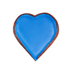 Gingerbread in the form of a heart with blue glaze. Isolated on white.