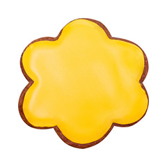 Gingerbread in the form of a flower with yellow glaze. Isolated on white.