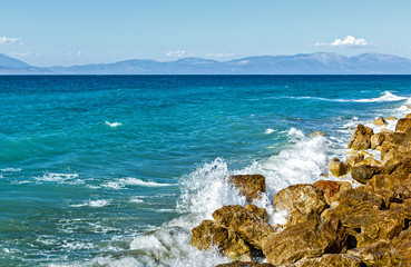 Corinthia. Corinthian Gulf. Stones, waves, splashes.
