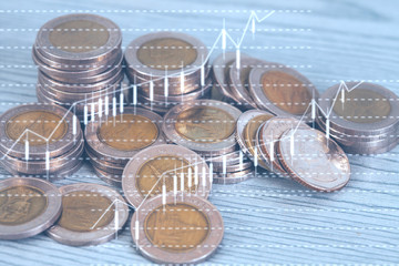 Stack of coins with business graph for finance and banking concept.