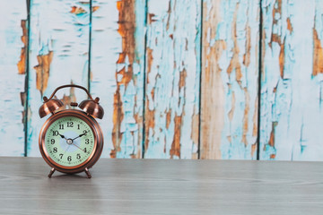 Vintage alarm clock on wood background