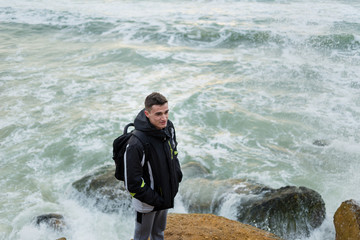 photo traveler on a rock by the sea