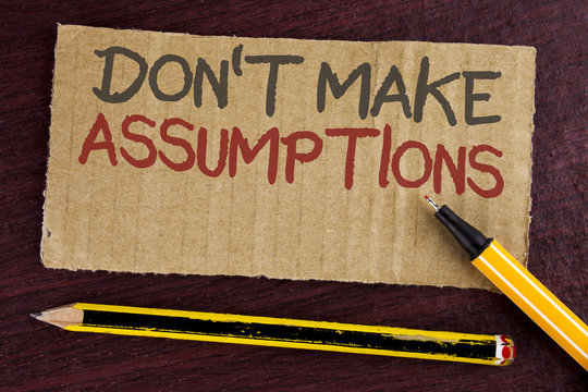 Text sign showing Do not Make Assumptions. Conceptual photo predict events future without clue Alternative Facts written on Cardboard Piece on wooden background Led Pen and Pencil next to it.