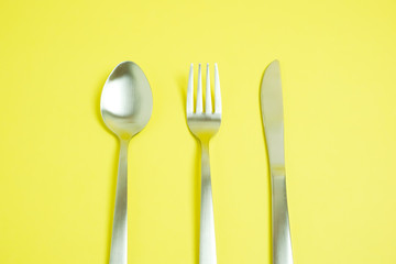 a knife and a fork and a spoon.　ナイフとフォークとスプーン　黄色背景