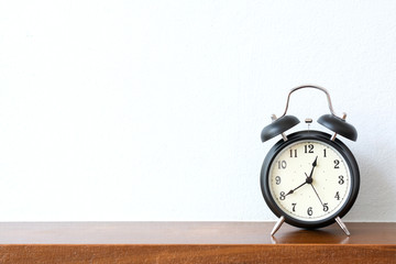 Black alarm clock on the table with copy space